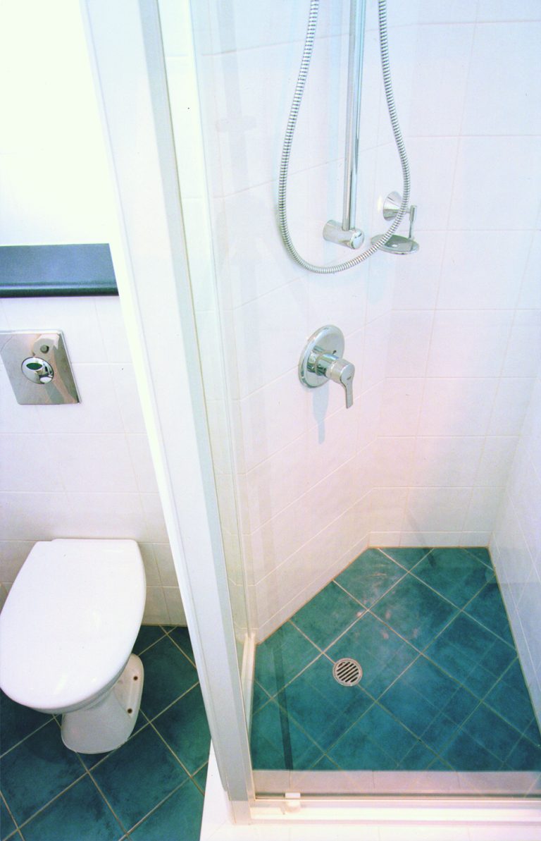 bathroom toilet with induct cistern shower truncated to conceal soil pipes in duct